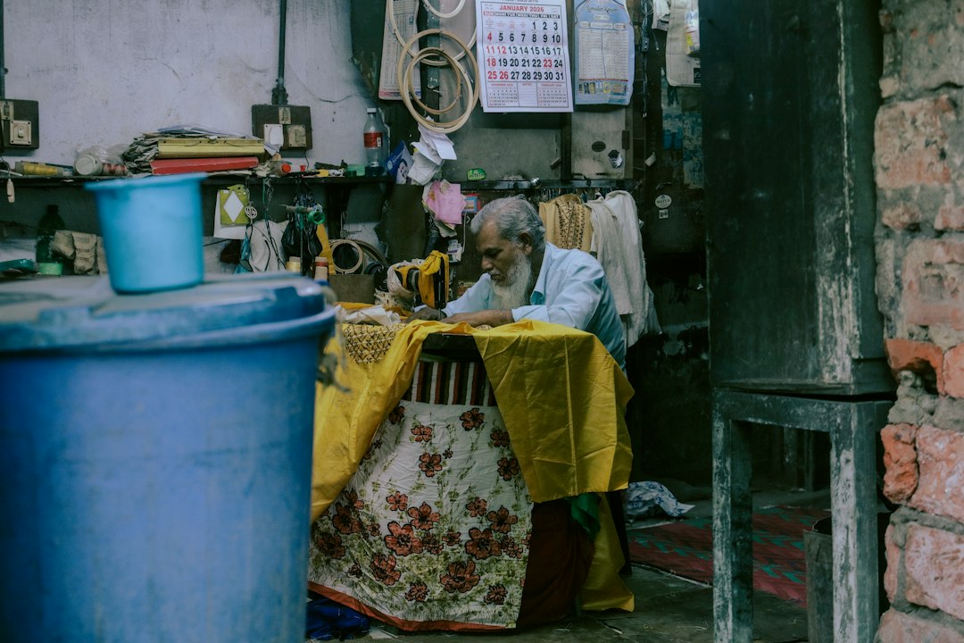A tailor carefully stitching a custom suit